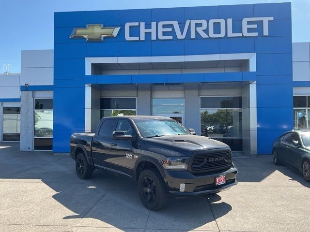 2015 RAM 1500 Sport in Brilliant Black Crystal Pearlcoat — front three-quarter view